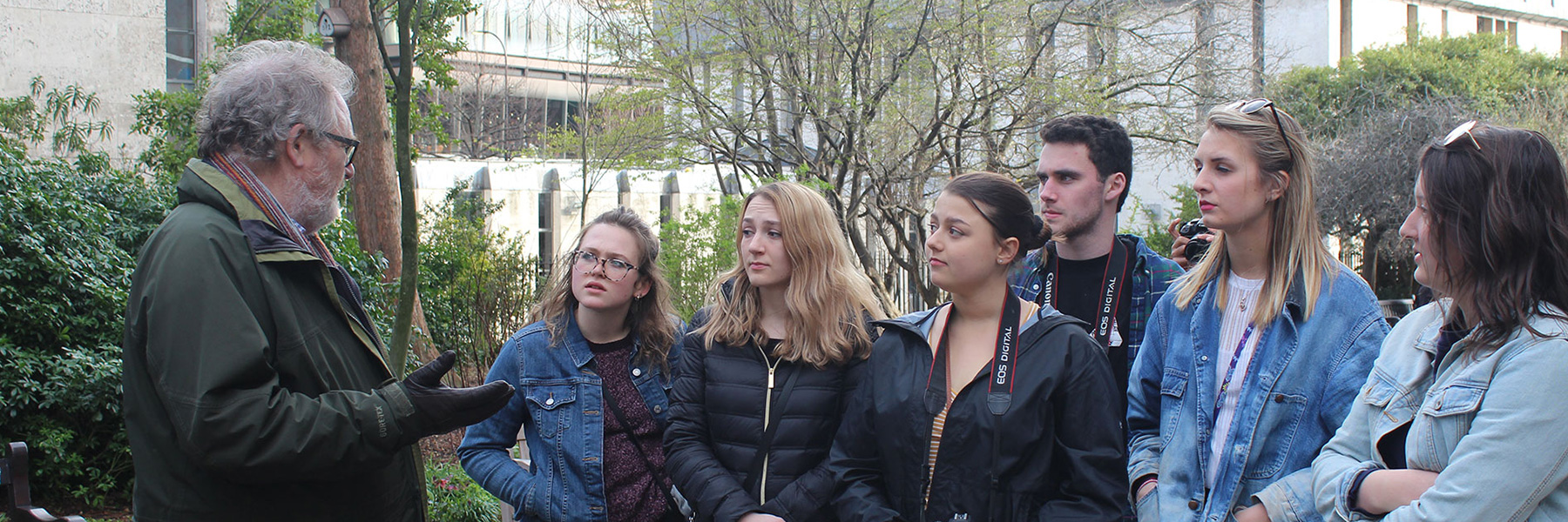 Tour guide talking to a group of students