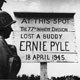 A sign reads: At this spot, the 77th infantry division lost a buddy. Ernie Pyle. 18 April 1945. 